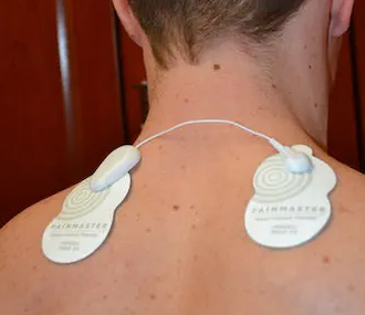Painmaster MCT patches applied to the back of the neck and shoulder.